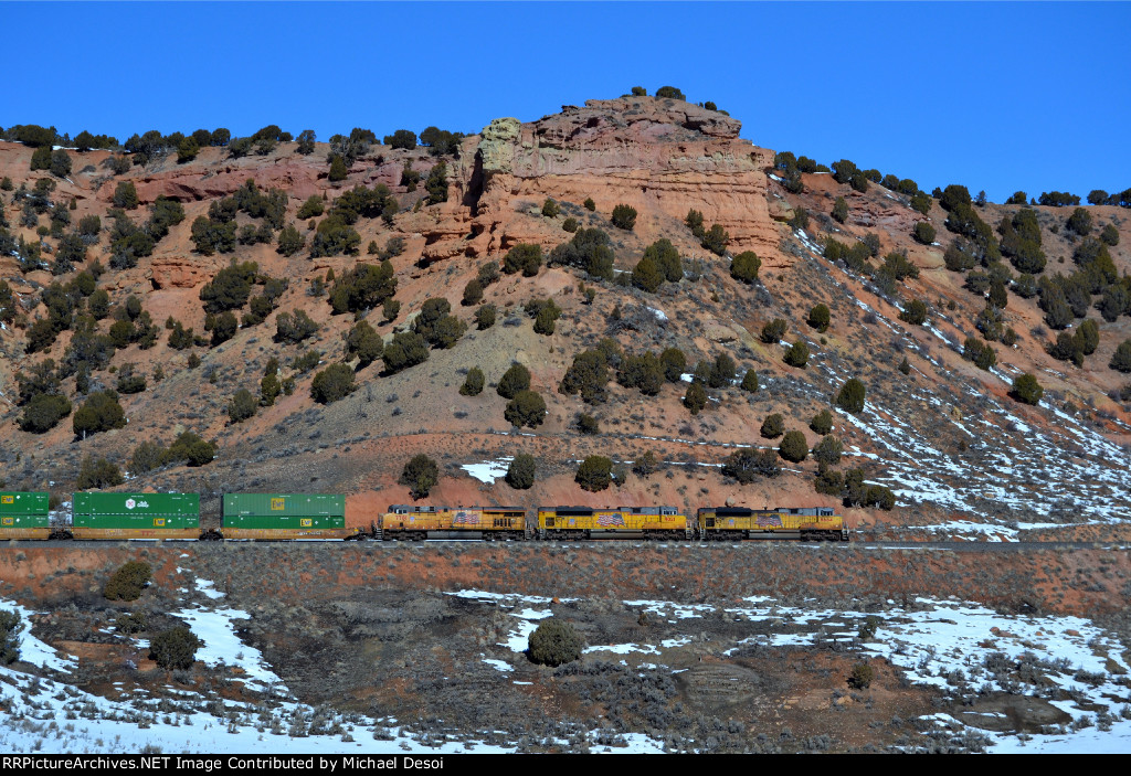 UP 8664, 9021, 7781 (SD70ACE, SD70ACE, C45ACCTE) lead an eastbound stack train at Castle Rock, Utah. February 19, 2022 {Winter Echofest}